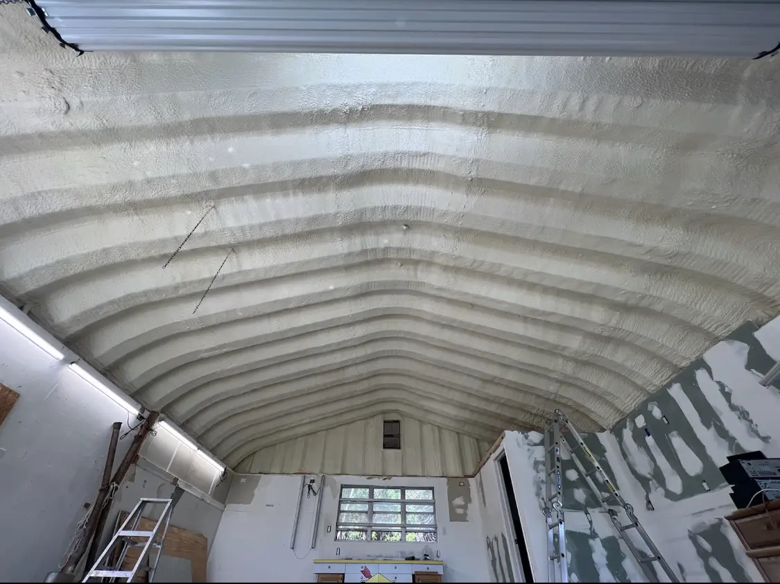 Spray polyurethane foam applied to the underside of a metal roof deck in Keene